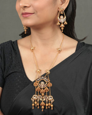 Heritage Gold Finish Pendant Set for Wedding Functions styled in traditional golden jewellery display