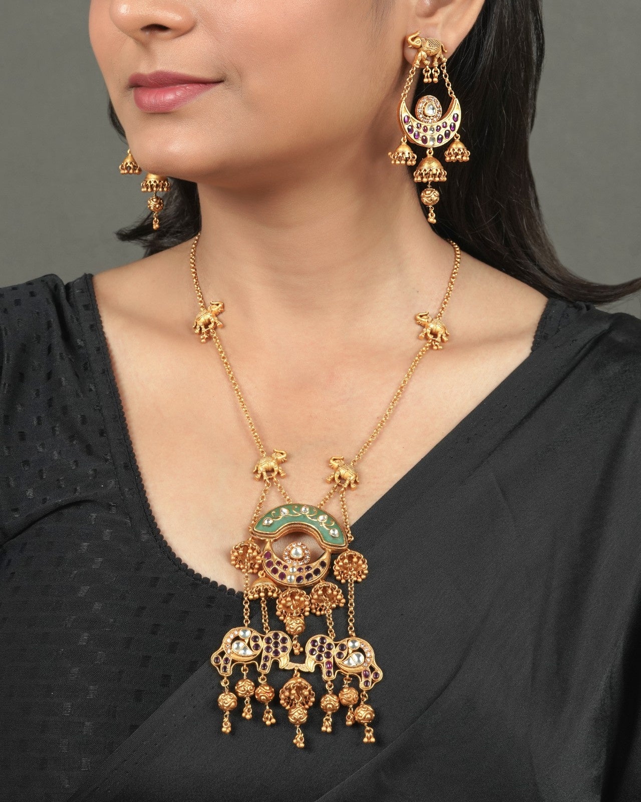 Heritage Gold Finish Pendant Set for Wedding Functions styled in traditional golden jewellery display