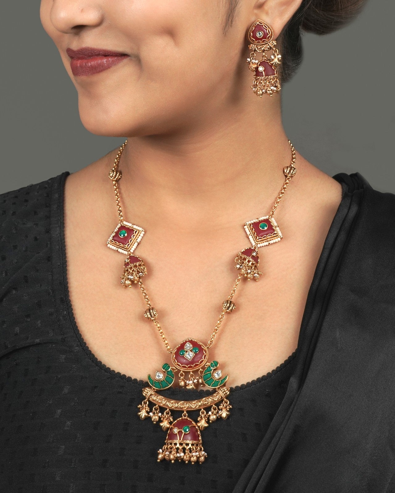 Elegant Golden Heritage Pendant Set for Party Wear styled in traditional golden jewellery display